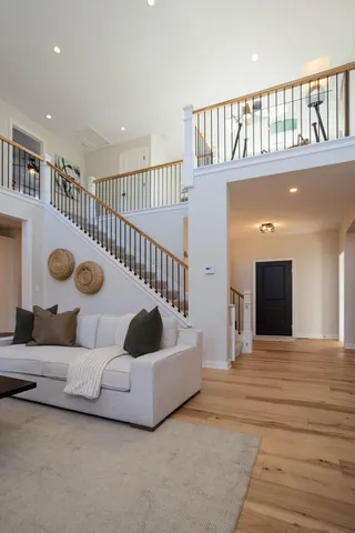 a spacious bedroom with a large bed and a chandelier