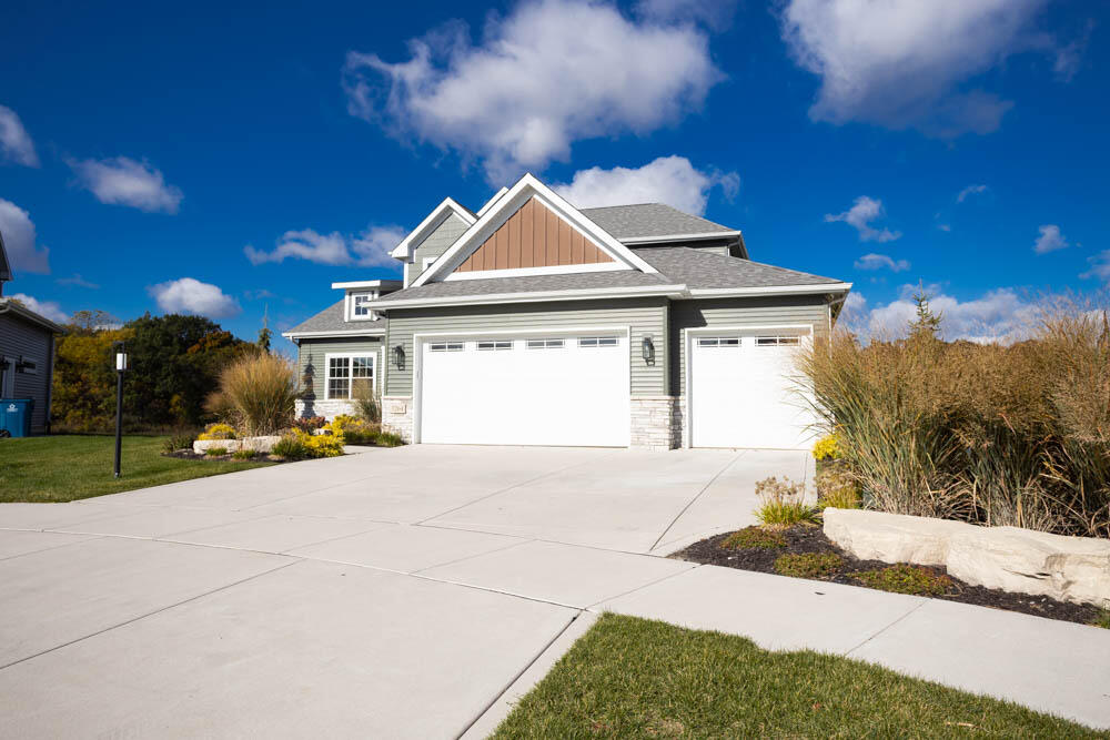 7264 East 115th Avenue Crown Point, IN 46307 - Photo 2 of 42 a front view of a house with a yard and garage