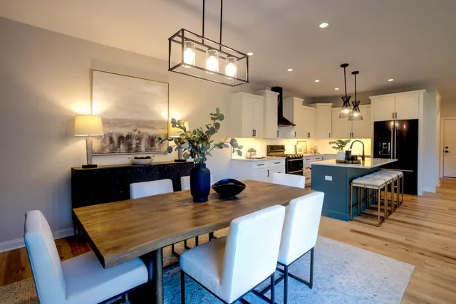 a dining room with granite countertop a table chairs and kitchen view