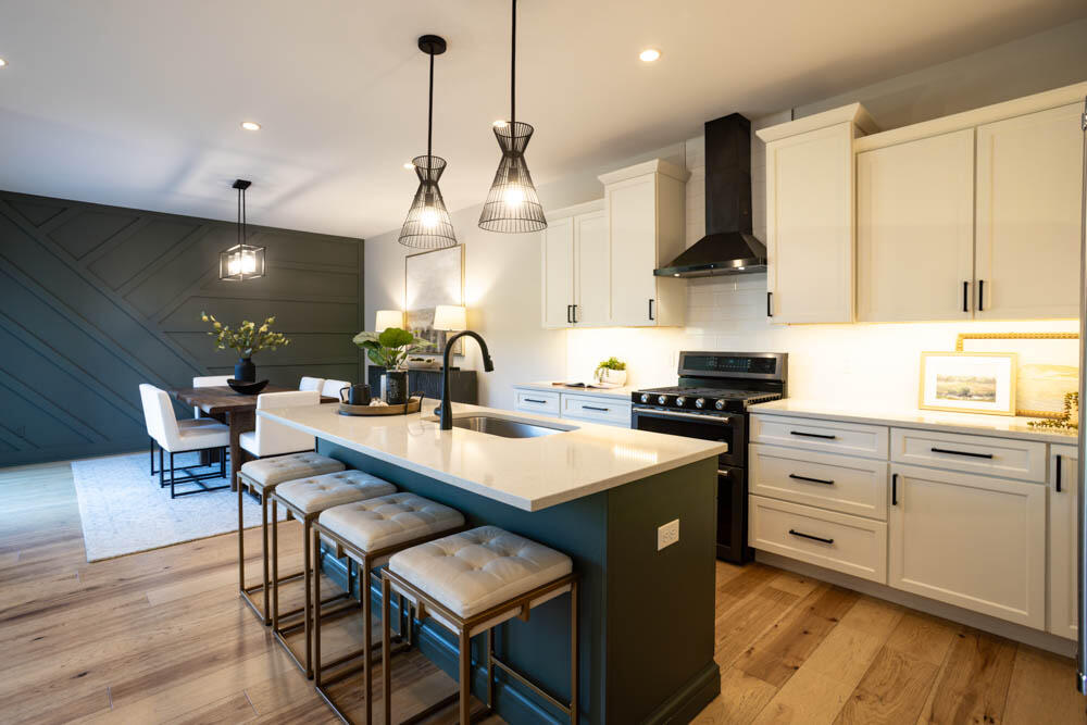 7264 East 115th Avenue Crown Point, IN 46307 - Photo 27 of 42 a large kitchen with stainless steel appliances a large center island attached withe living room