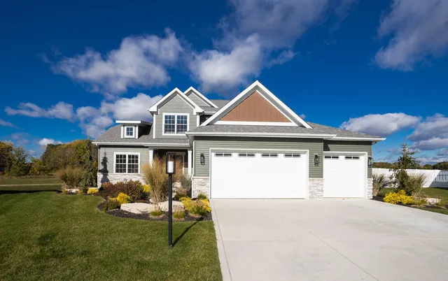 a front view of a house with a yard fire pit and outdoor seating