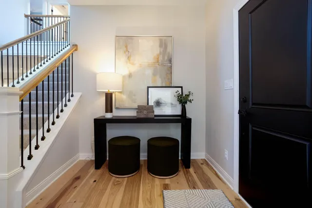 a view of entryway and hall with wooden floor
