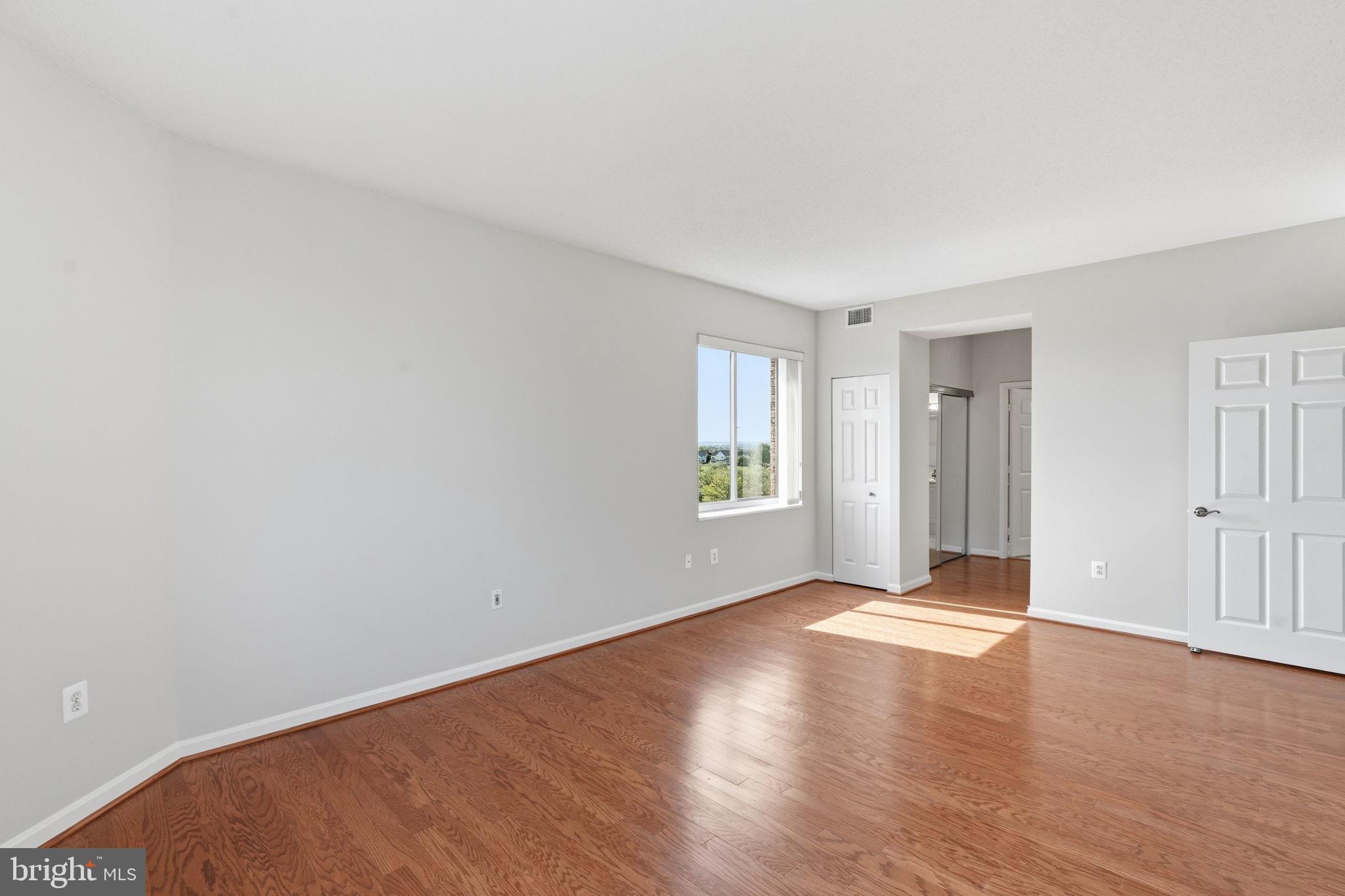 19365 Cypress Ridge Terrace, Unit 907 Leesburg, VA 20176 - Photo 27 of 77 Hardwood floors continue into the primary bedroom