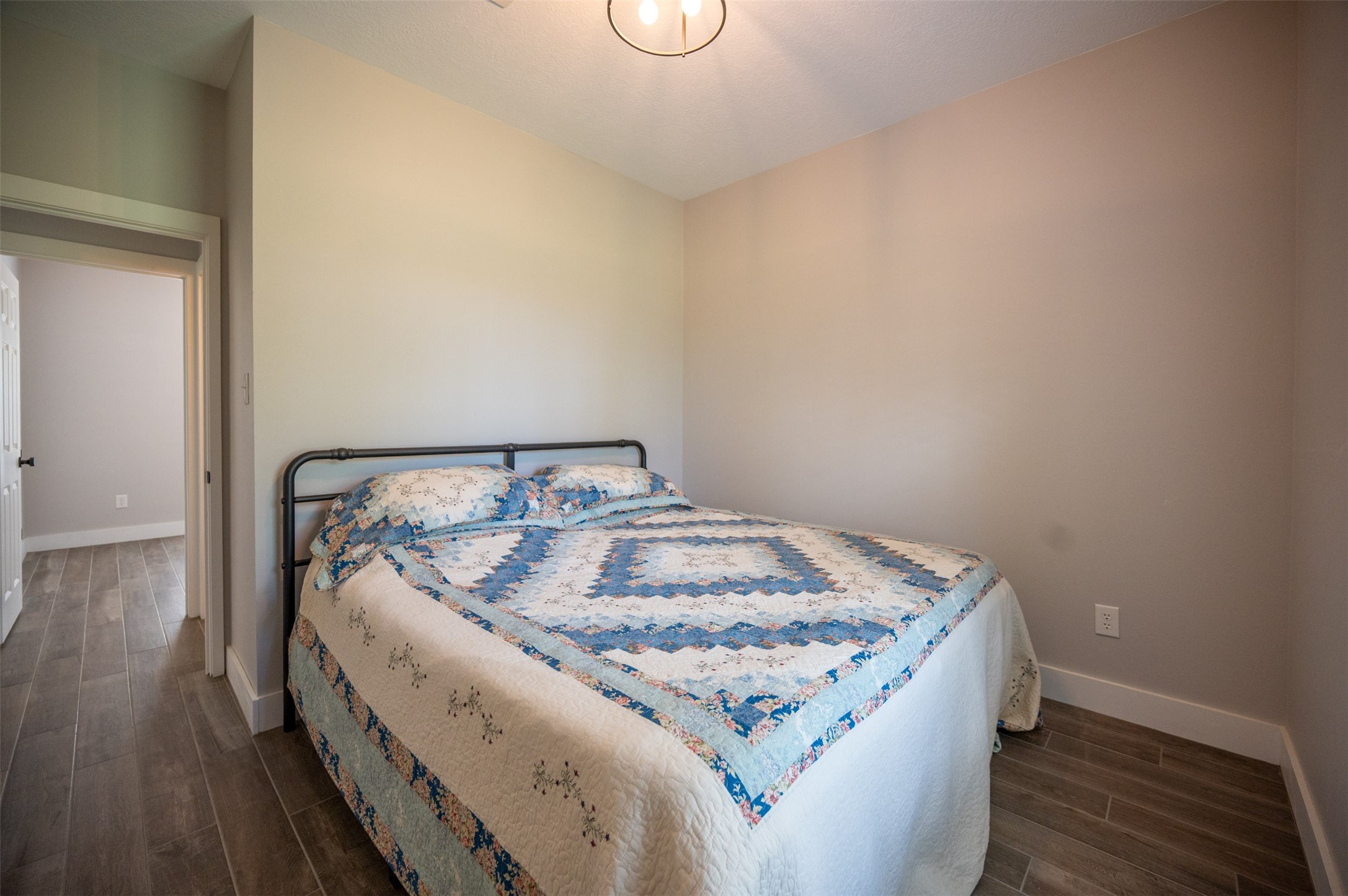 1068 County Road 3200 Colmesneil, TX 75938 - Photo 28 of 43 a bed sitting in a bedroom next to a window with wooden floor