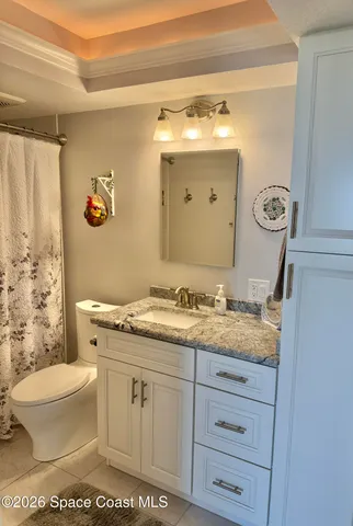 a balcony with wooden floor and city view