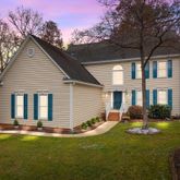 a front view of house with yard and green space