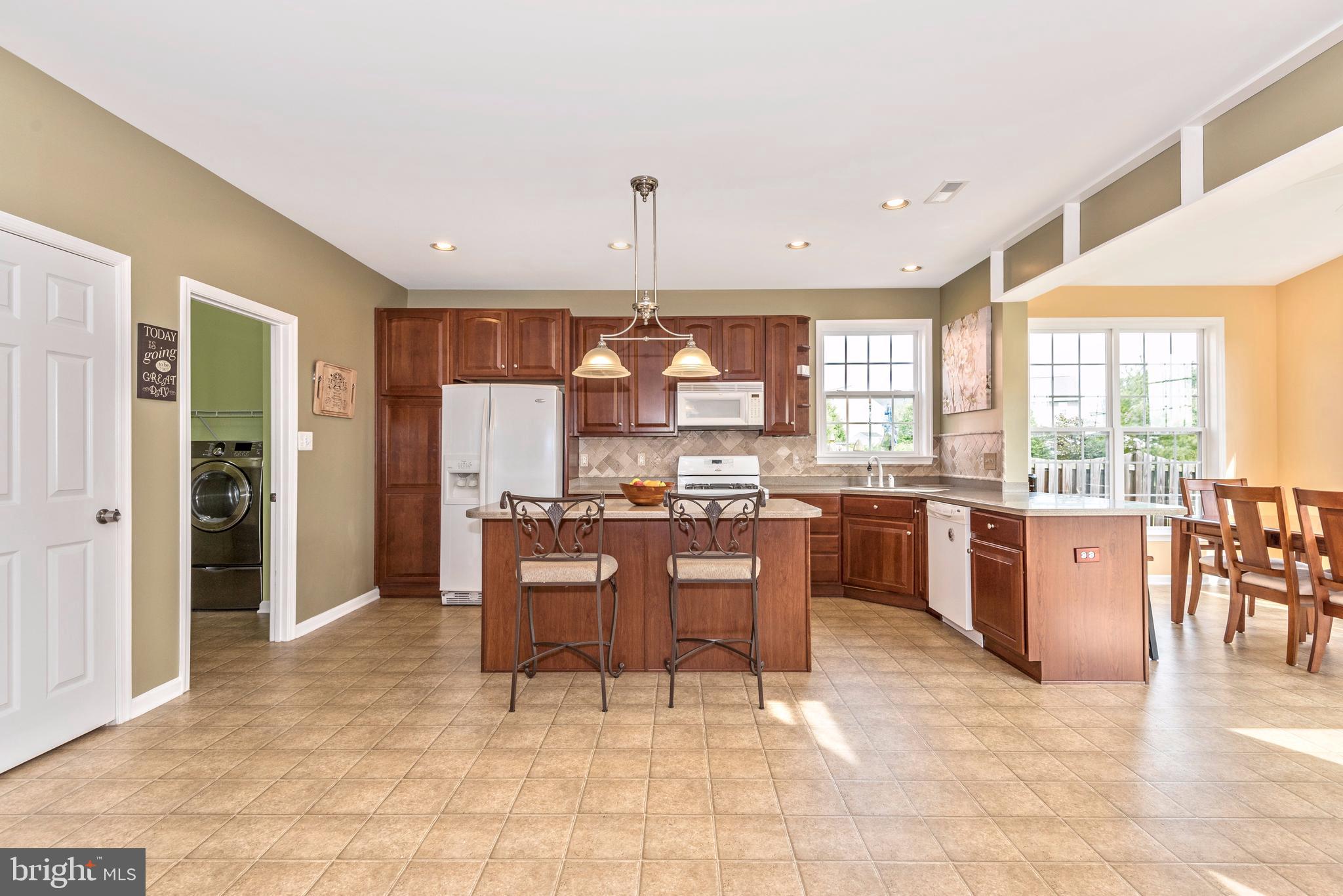 1713 Canal Run Drive Point of Rocks, MD 21777 - Photo 20 of 38 a open kitchen with granite countertop a refrigerator a stove top oven a sink island and chairs