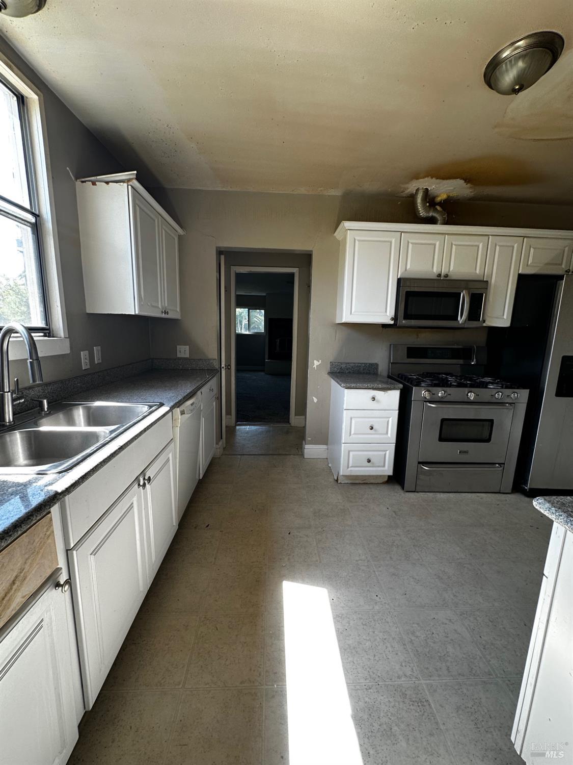 2015 Tennessee Street Vallejo, CA 94590 - Photo 14 of 29 a kitchen with stainless steel appliances a stove sink and cabinets
