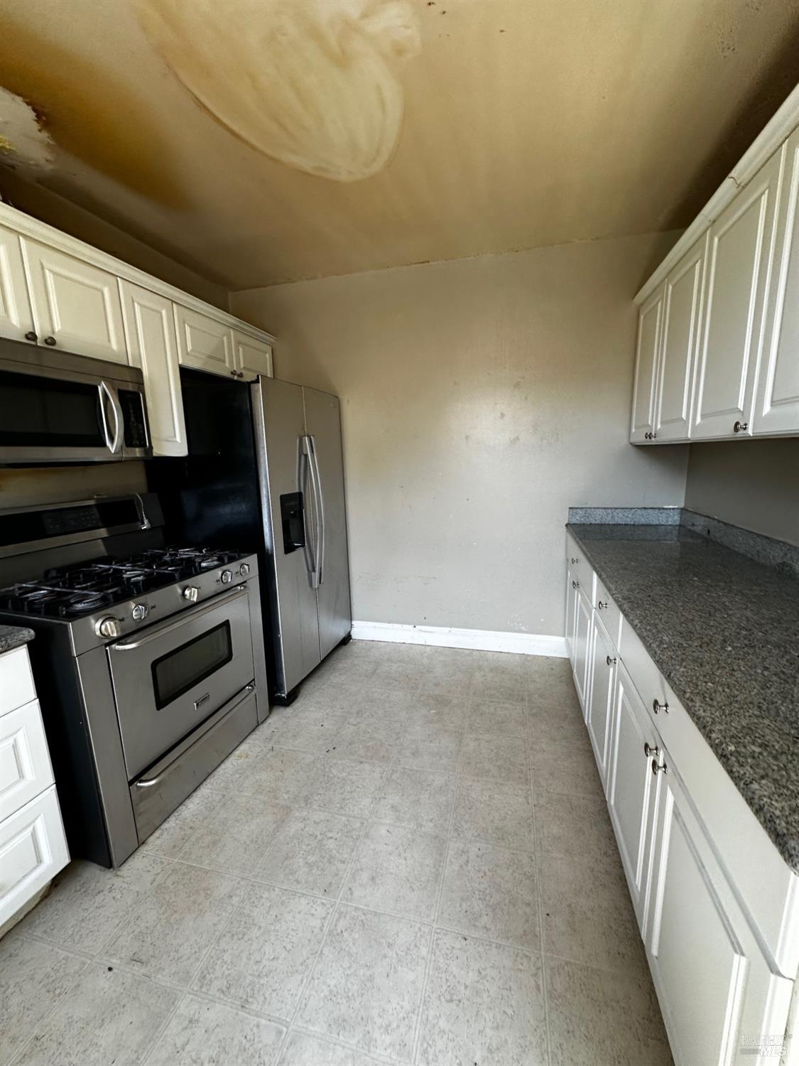 2015 Tennessee Street Vallejo, CA 94590 - Photo 15 of 29 a kitchen with stainless steel appliances a stove a microwave and a sink