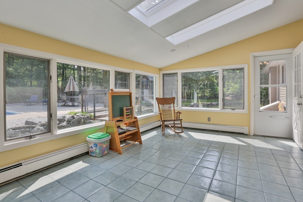 101 Chestnut Road Tyngsborough, MA 01879 - Photo 12 of 26 a living room filled with furniture and large windows