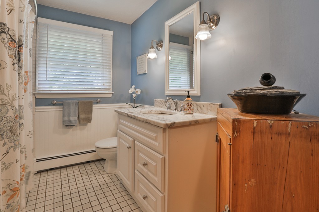 101 Chestnut Road Tyngsborough, MA 01879 - Photo 16 of 26 a bathroom with a sink a toilet and a mirror