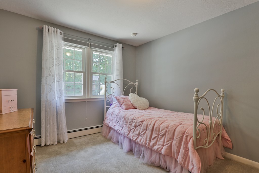 101 Chestnut Road Tyngsborough, MA 01879 - Photo 17 of 26 a bedroom with a bed and a window