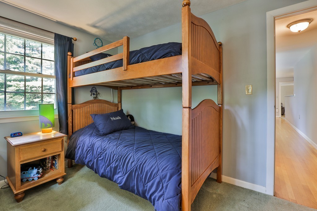 101 Chestnut Road Tyngsborough, MA 01879 - Photo 18 of 26 a bedroom with a bed and a fireplace