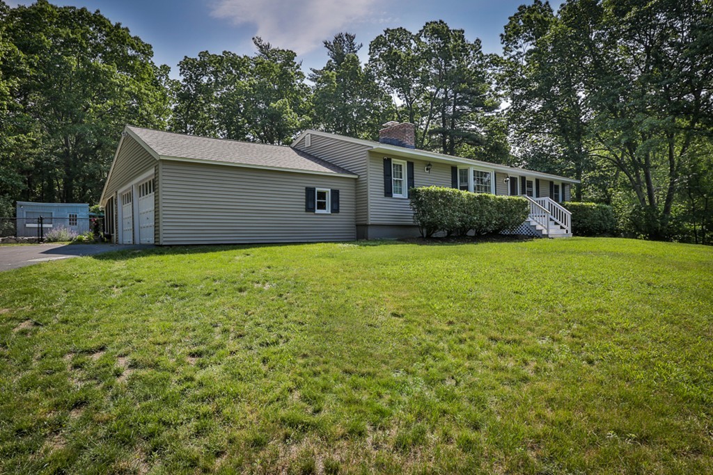 101 Chestnut Road Tyngsborough, MA 01879 - Photo 26 of 26 a front view of a house with yard and trees