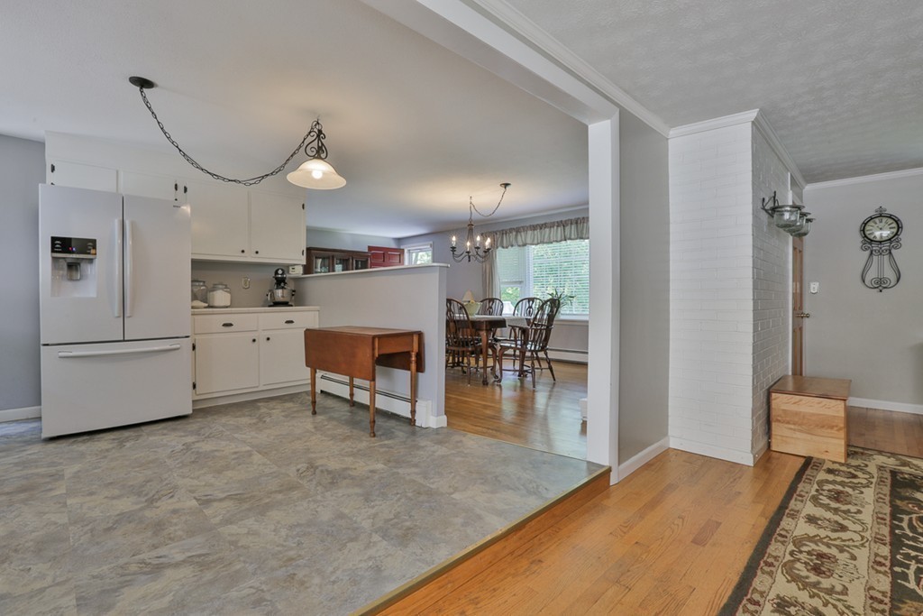 101 Chestnut Road Tyngsborough, MA 01879 - Photo 5 of 26 a open kitchen with cabinets table and chairs