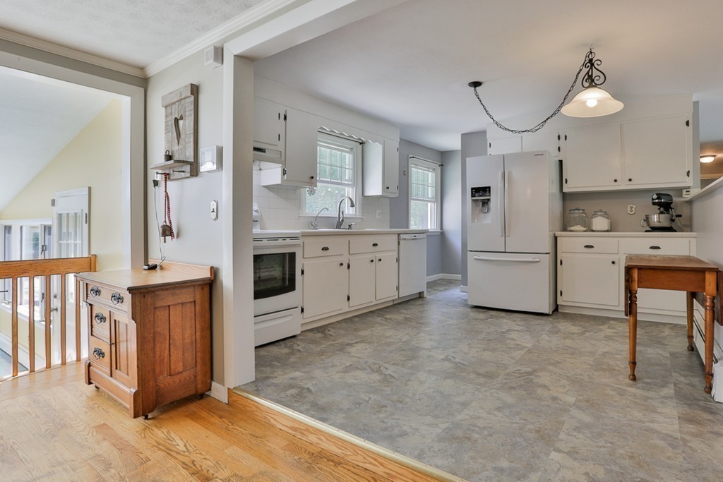 101 Chestnut Road Tyngsborough, MA 01879 - Photo 6 of 26 a large kitchen with cabinets and wooden floor