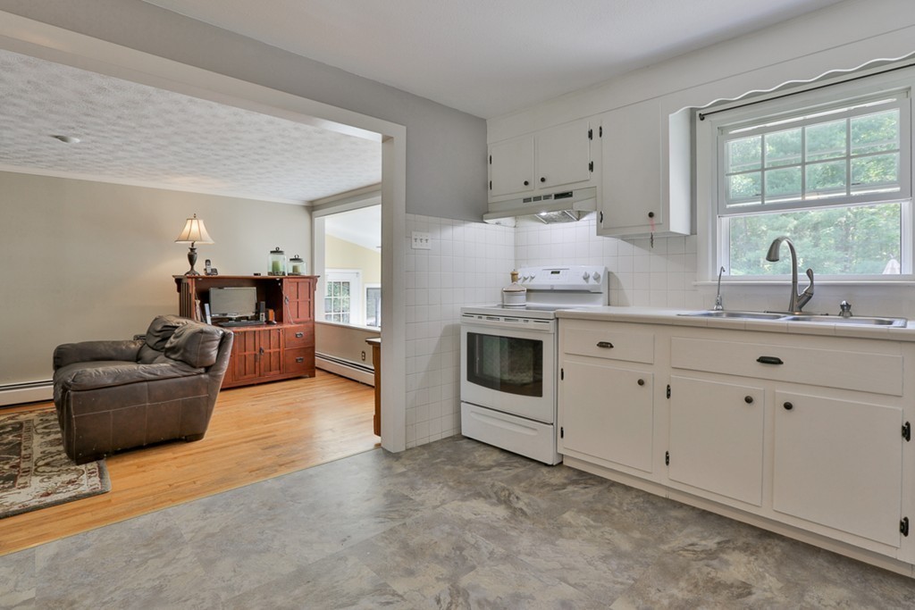 101 Chestnut Road Tyngsborough, MA 01879 - Photo 7 of 26 a kitchen with furniture a stove and a window