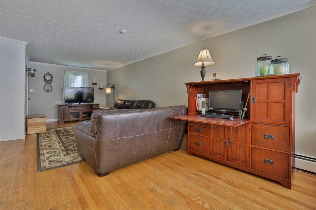 101 Chestnut Road Tyngsborough, MA 01879 - Photo 8 of 26 a living room with furniture and a flat screen tv