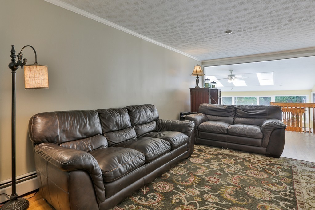 101 Chestnut Road Tyngsborough, MA 01879 - Photo 9 of 26 a living room with furniture and a couch