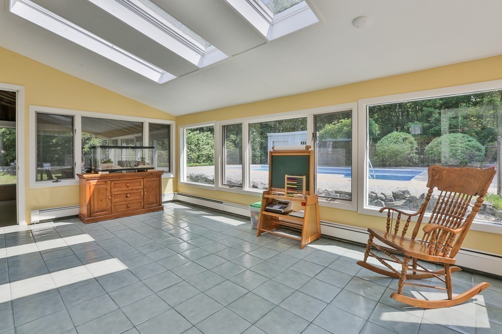 101 Chestnut Road Tyngsborough, MA 01879 - Photo 10 of 26 a view of living room filled with furniture and large windows