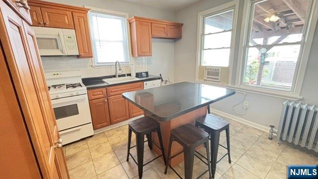 760 Hamilton Street, Unit 1 Harrison, NJ 07029 - Photo 15 of 23 a kitchen with stainless steel appliances granite countertop a stove a sink and a microwave