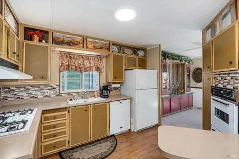 a kitchen with a refrigerator and a stove