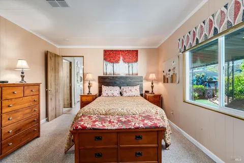 a bed sitting in a bedroom next to a window