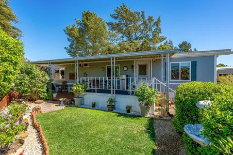 a view of a house with backyard and a garden