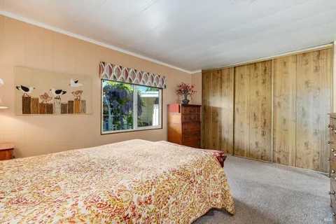 a bedroom with a large bed and a dresser