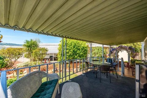 a view of a chairs and table in patio