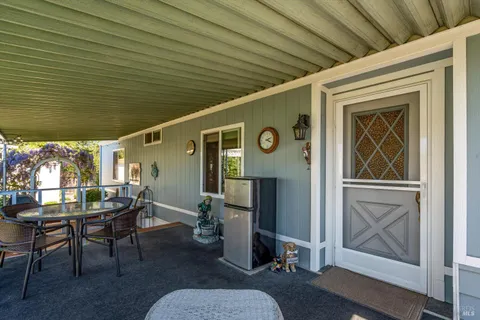 a front view of a house with outdoor seating