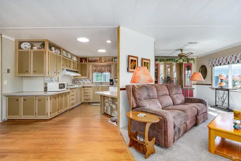 a living room with furniture and a wooden floor