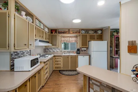 a kitchen with refrigerator and cabinets