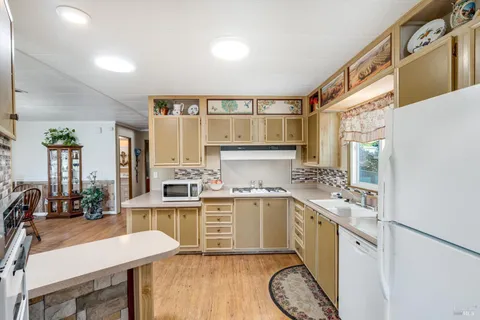 a kitchen with a stove a sink and a refrigerator