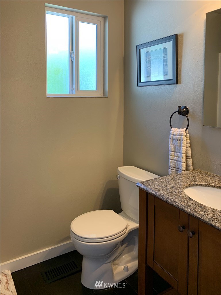 21904 1st Place West Bothell, WA 98021 - Photo 27 of 35 a bathroom with a granite countertop toilet and a sink