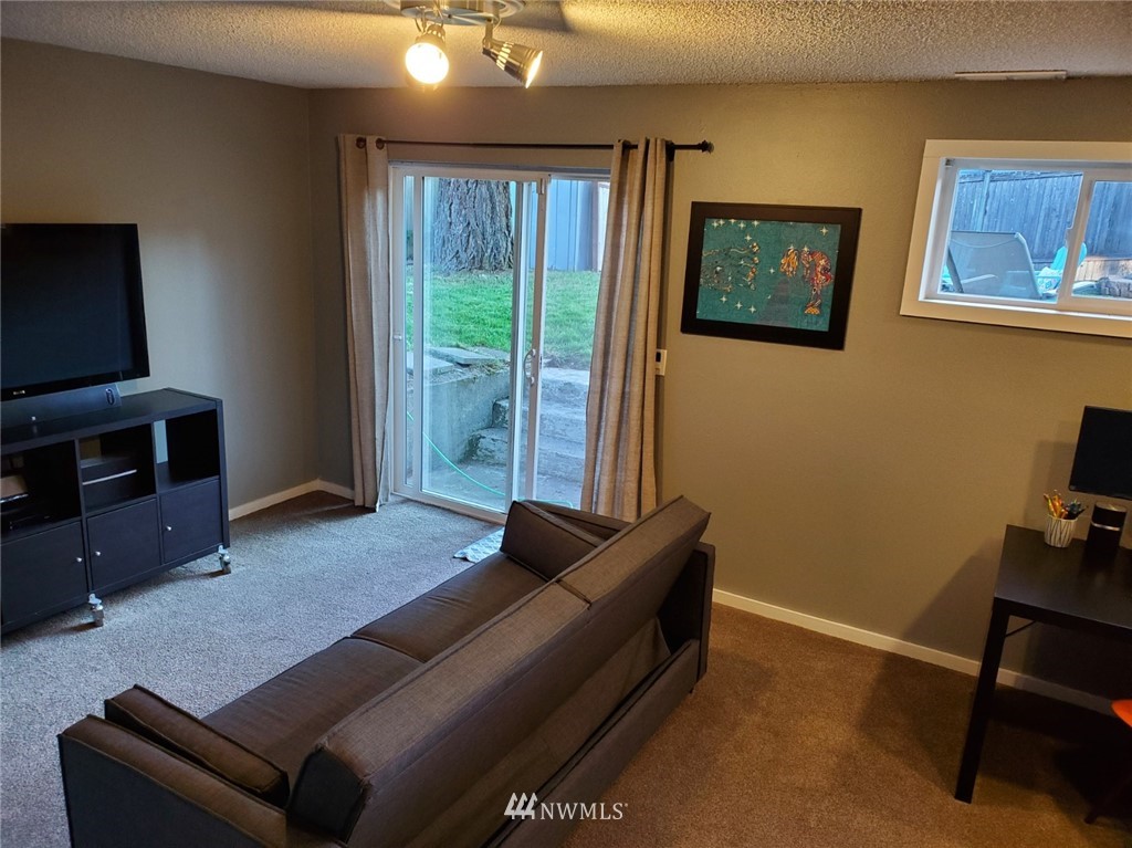 21904 1st Place West Bothell, WA 98021 - Photo 29 of 35 a living room with furniture and a flat screen tv