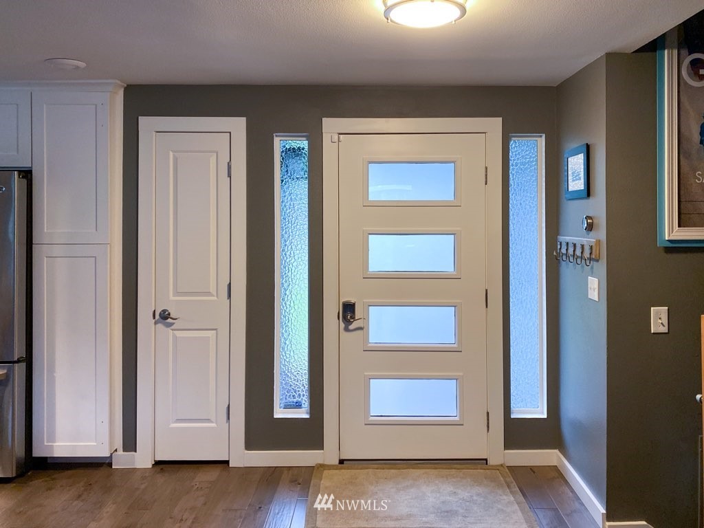 21904 1st Place West Bothell, WA 98021 - Photo 4 of 35 a view of a hallway with wooden floor