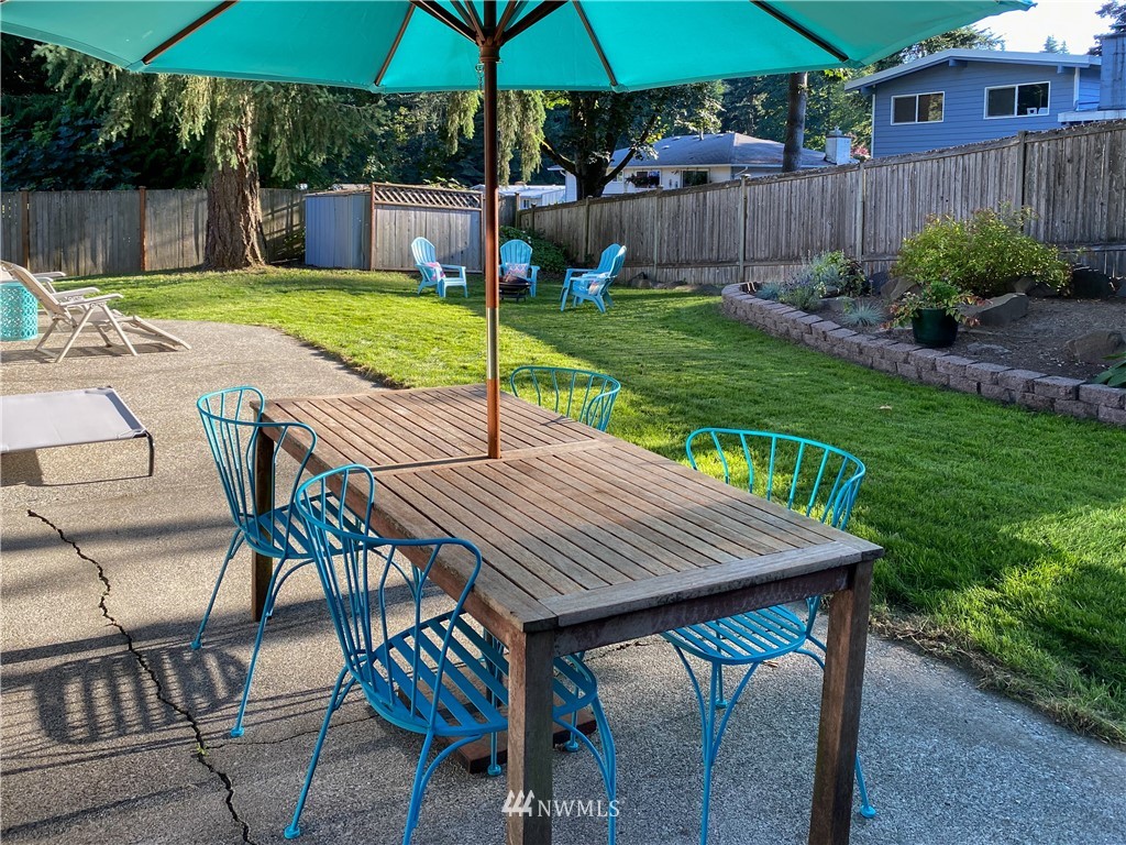21904 1st Place West Bothell, WA 98021 - Photo 33 of 35 a view of a patio with table and chairs under an umbrella
