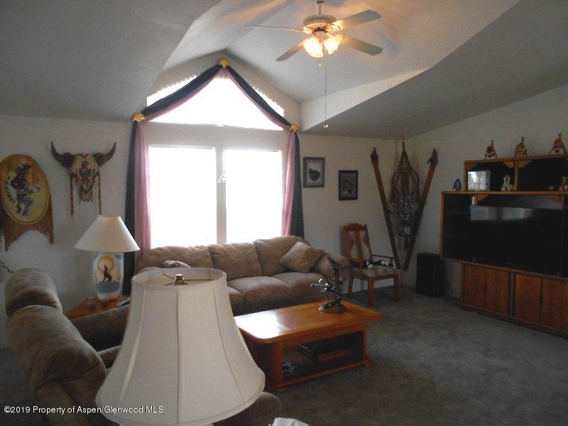 520 Lariat Road Silt, CO 81652 - Photo 17 of 30 a living room with furniture and a flat screen tv