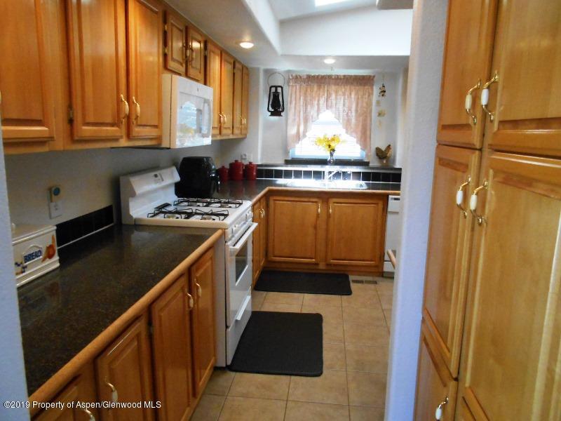 520 Lariat Road Silt, CO 81652 - Photo 19 of 30 a kitchen with stainless steel appliances a stove a sink and a refrigerator