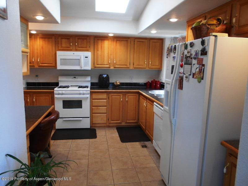 520 Lariat Road Silt, CO 81652 - Photo 20 of 30 a kitchen with stainless steel appliances granite countertop a refrigerator sink and stove