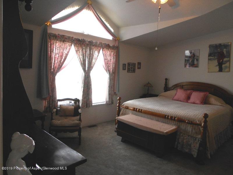 520 Lariat Road Silt, CO 81652 - Photo 28 of 30 a bedroom with a bed and window