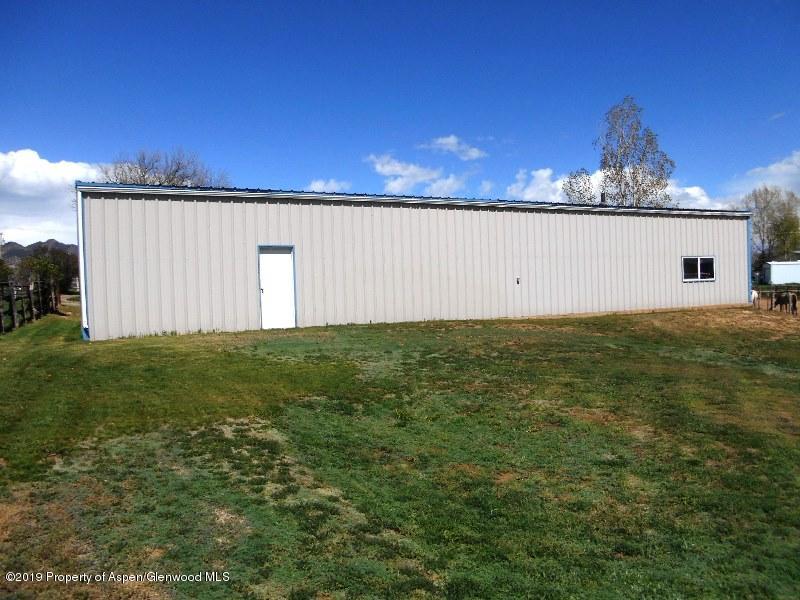 520 Lariat Road Silt, CO 81652 - Photo 10 of 30 a view of a big yard with an tree and a fence