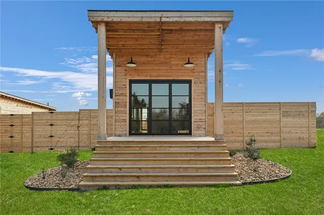 a front view of a house with a garden