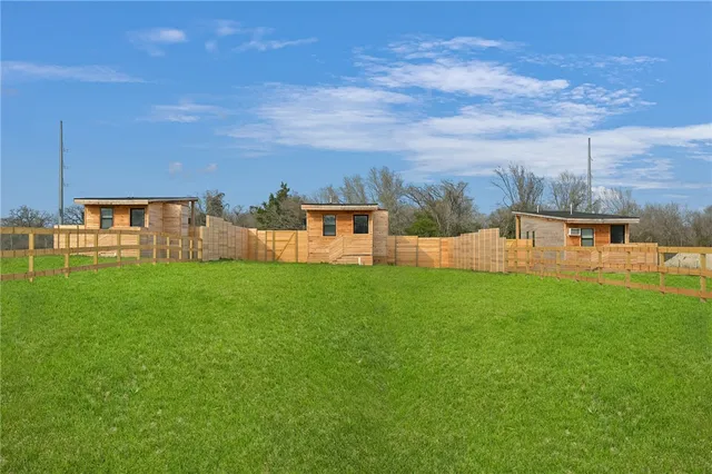 a view of a house with a backyard