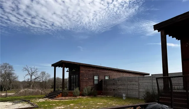 a view of a house with a small yard