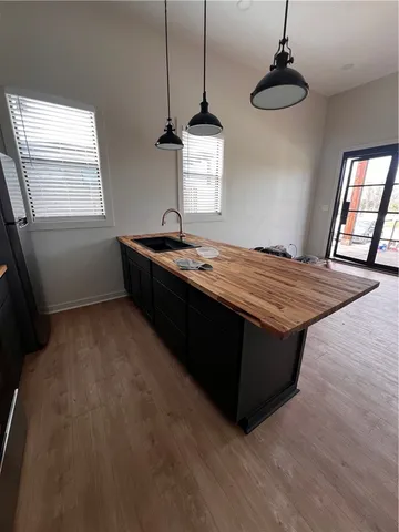 a room with kitchen island a wooden floor and window