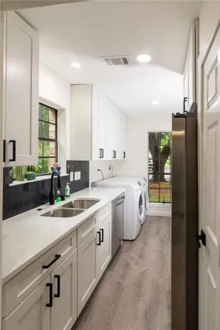 a kitchen with a sink and cabinets