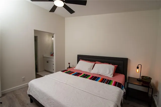 a bedroom with a bed and a lamp