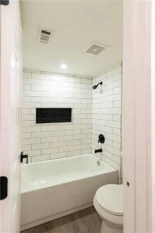a bathroom with a bathtub and a toilet